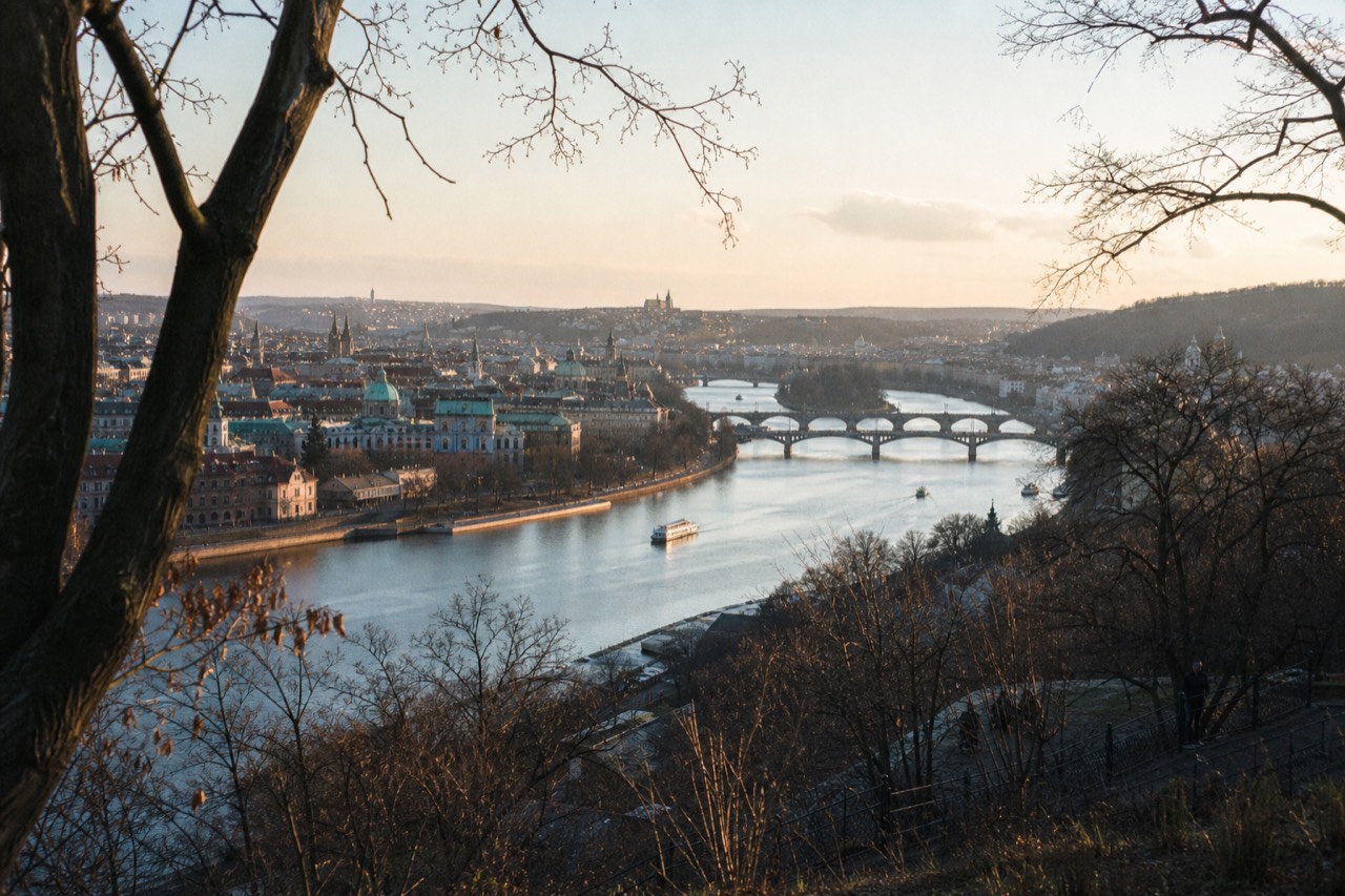 The Vltava sweeping through Prague past Charles Bridge, the castle hill and St Vitus Cathedral at dusk